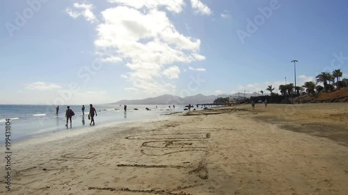 Walking on the sandy white beach in Puerto del Carmen Lanzarote Spain