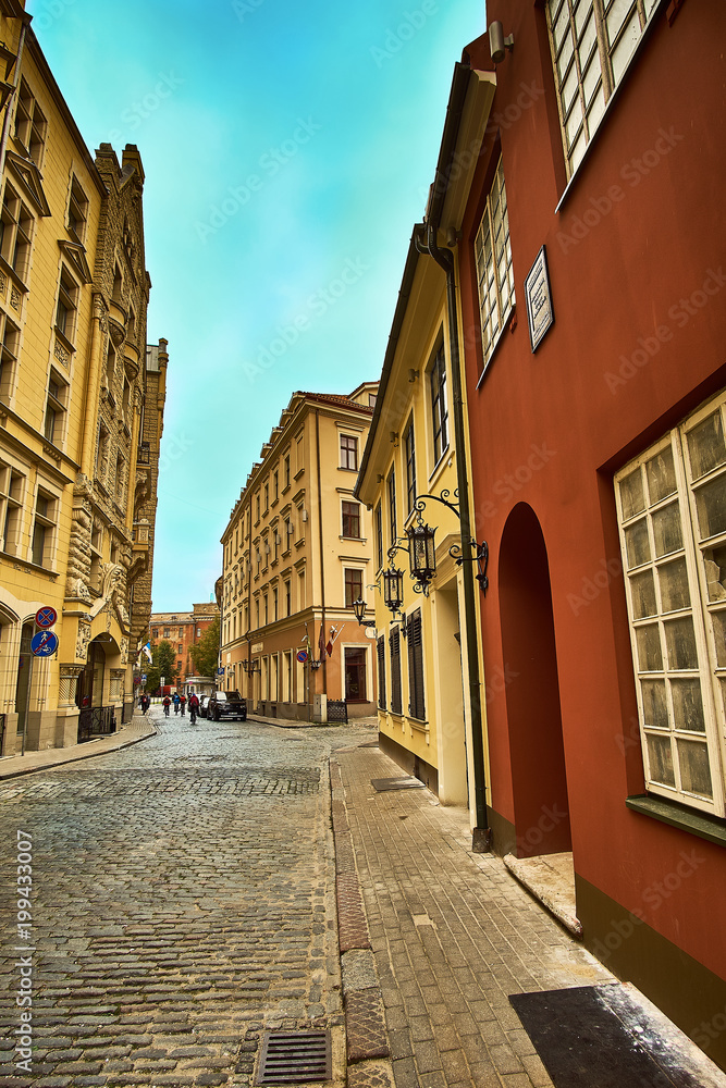 Old medieval morning narrow street in Riga, Latvia. Retro styled.