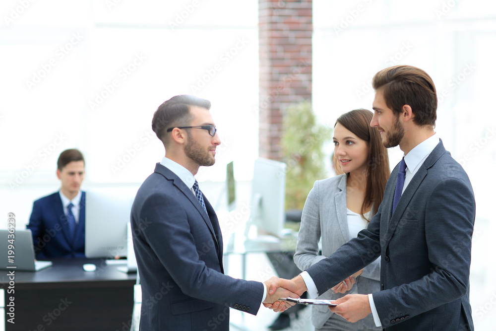 Young man introducing himself at meeting to his partners. Young man introducing himself at meeting to his partners.