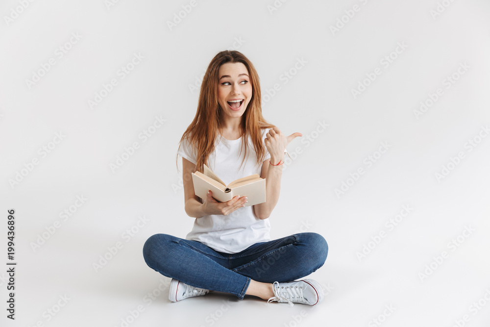 Portrait of a happy young girl holding book