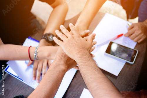 team work concept.Close up of people putting their hands together