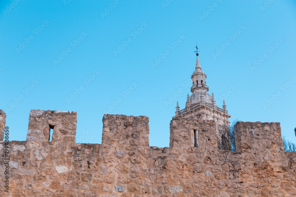 main public access to Burgo de Osma medieval town, with public street and tower of cathedral, landmark and monument from thirteenth century, in Soria, Spain, Europe