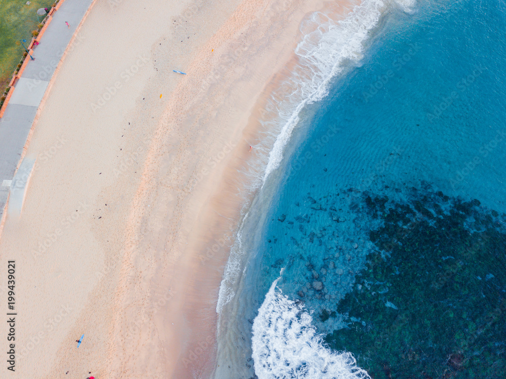 A clean coastline of beach from above.