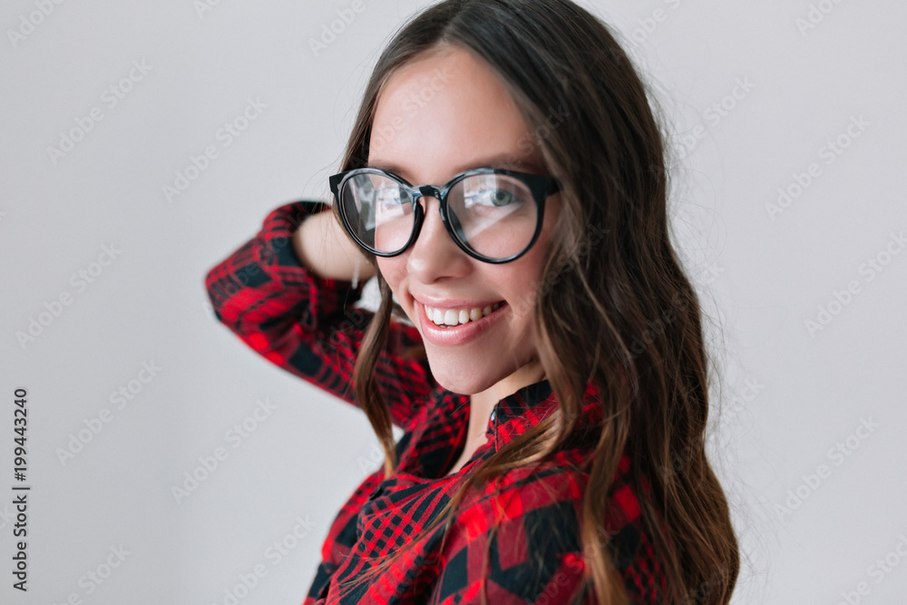 Portrait of charismatic and charming woman with long hair wearing sylish glasses, smiling widely, looking happy and smiling at camera, true emotions, lifestyle, people Portrait of charismatic and charming woman with long hair wearing sylish glasses, smiling widely, looking happy and smiling at camera, true emotions, lifestyle, people