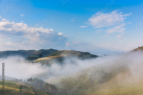 Beautiful mountain landscape of a foggy morning with trees and clouds, Dumesti, Salciua, Apuseni, Romania