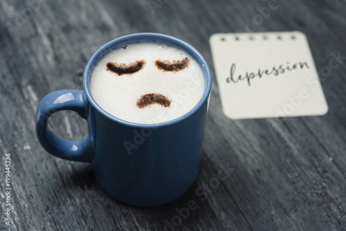 cup of cappuccino with a sad face. photo