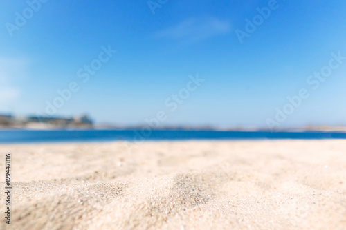 Close up sand with blurred sea sky background  summer day  copy space or for product