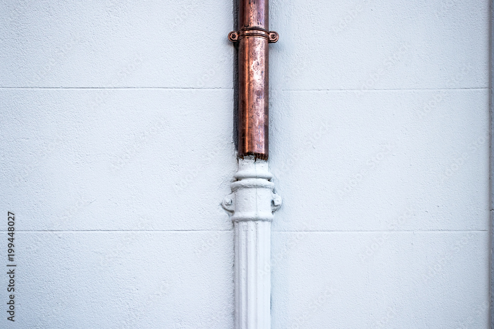 Copper and white painted pipes junction, old outer pipe Copper and white painted pipes junction, old outer pipe