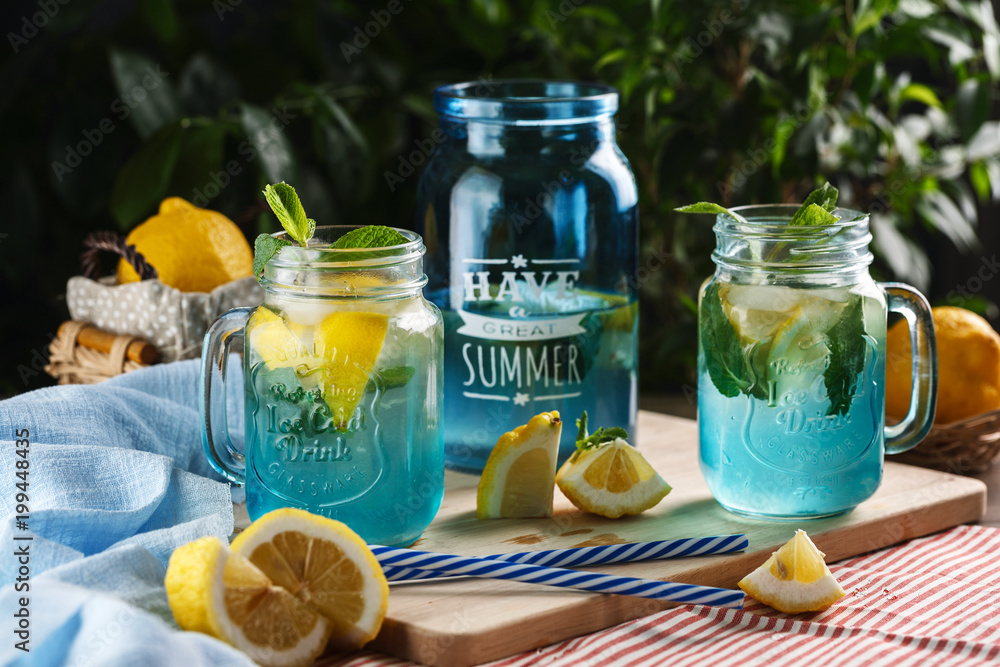 Citrus lemonade water with lemon sliced and mint in blue jar Citrus lemonade water with lemon sliced and mint in blue jar