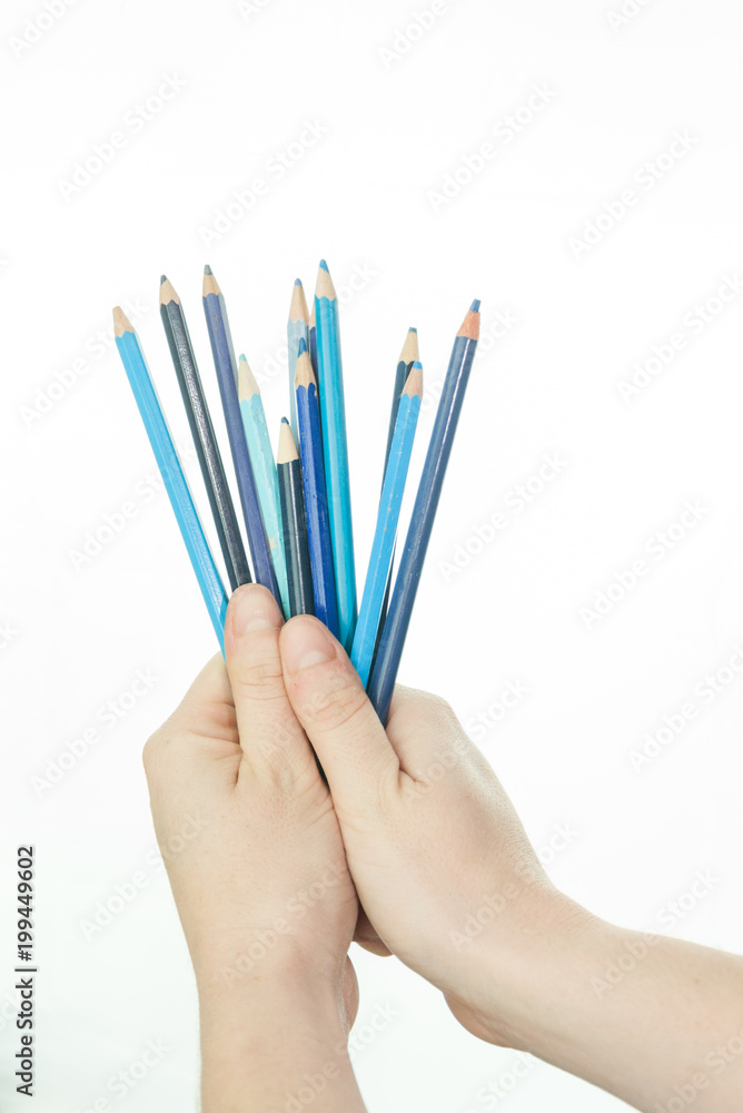 hand with colored pencils on white background hand with colored pencils on white background
