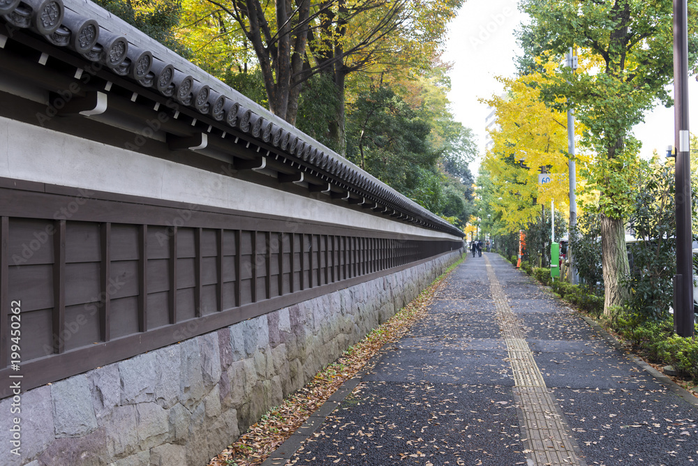 Ancient Traditional Japanese stone wall and old tiled roof and