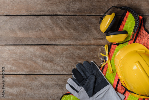 Standard construction safety equipment on wooden table. top view