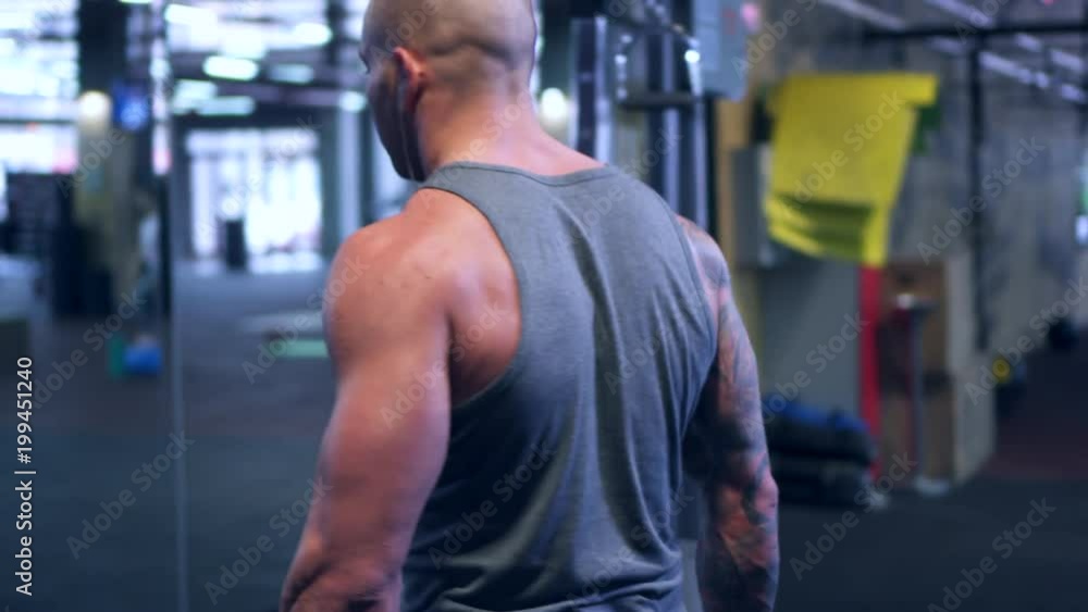Strong bodybuilder training chest with dumbbells Strong bodybuilder training chest with dumbbells