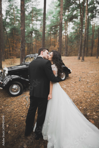 Photography Just married couple in the luxury retro car on their wedding day