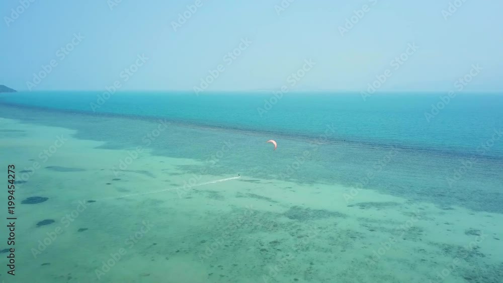 Aerial view on kiteboarders near the beach in Thailand Aerial view on kiteboarders near the beach in Thailand