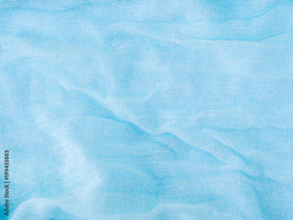 Blue lightweight scarf on a blue pastel background Blue lightweight scarf on a blue pastel background