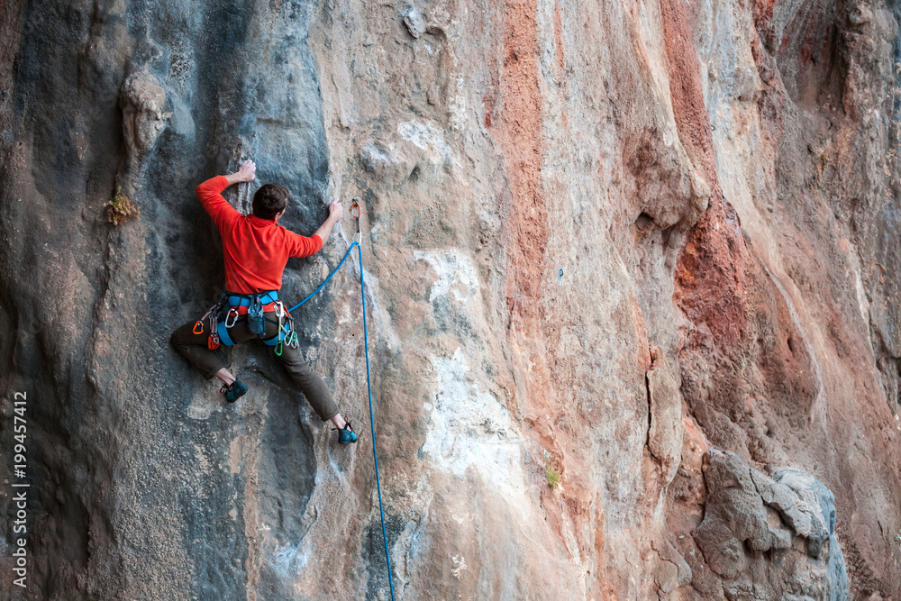 Fototapeta premium A man climbs the rock.