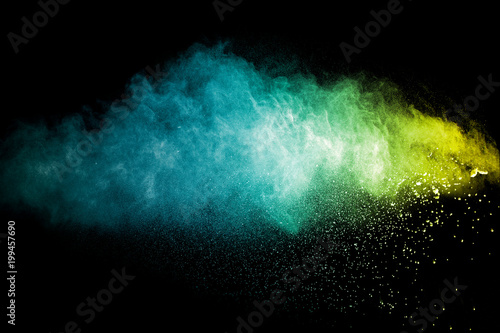 color powder explosion cloud isolated on black background. Freeze motion of color dust particles splashing.