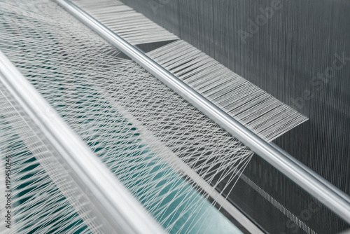 macro shot of a stretched thread. machinery and equipment in a textile factory