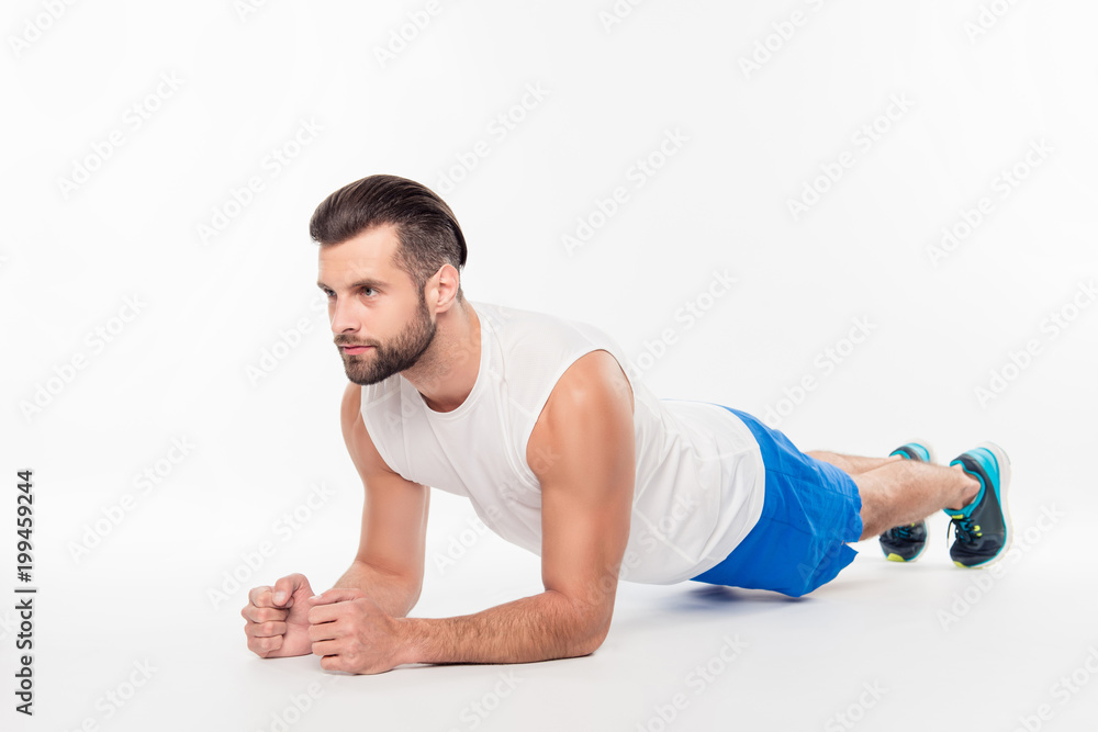 Full size portrait of active, sporty, attractive, athletic person making, doing plank on elbows isolated on white background Full size portrait of active, sporty, attractive, athletic person making, doing plank on elbows isolated on white background
