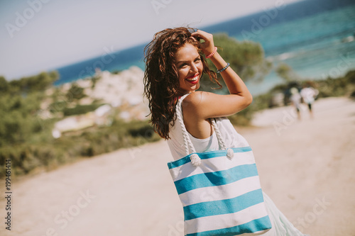 Pretty young woman with bag...
