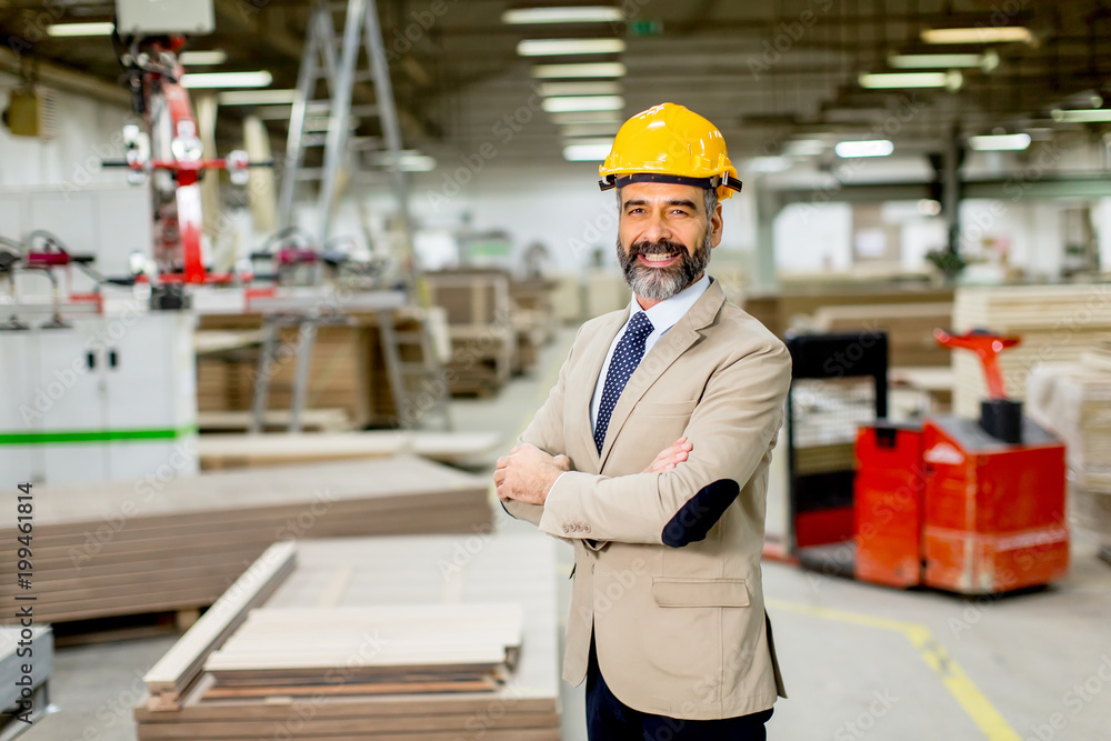 Portrait of handsome businessman in suit with helmet in a warehouse Portrait of handsome businessman in suit with helmet in a warehouse