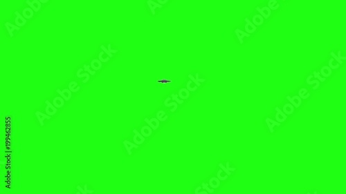 UFO - Flying saucer flying over camera into the distance - over green screen - rotating metallic with blue lights