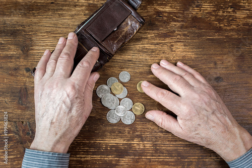 Hands of an old man counting money, rubles. The concept of poverty, austerity in old age.