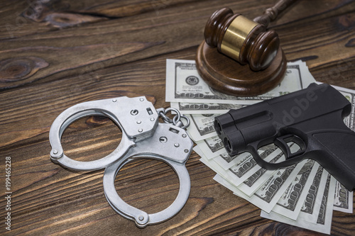 traumatic gun, money, hammer of the judge. Crime, robbery with the help of traumatic weapons, responsibility. committal and punishment, court and law