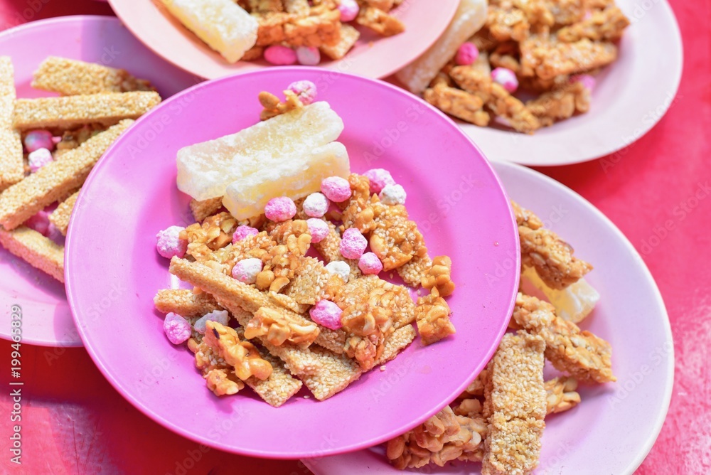 Plate of Traditional Chinese Snacks Consisting of Peanuts and Sesame Candy Bars Plate of Traditional Chinese Snacks Consisting of Peanuts and Sesame Candy Bars