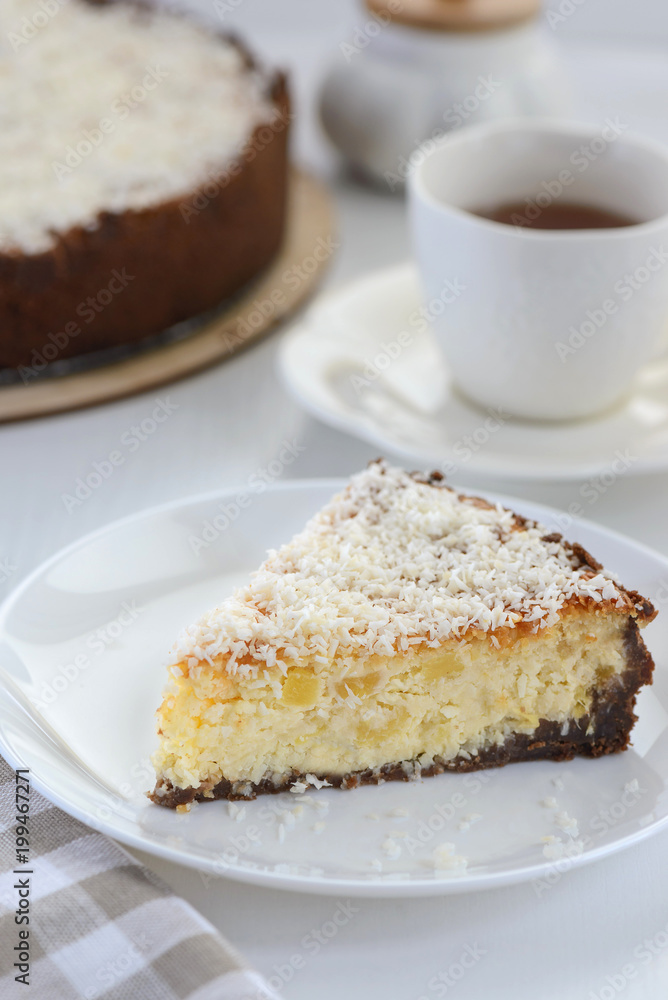 slice of a cheesecake with a cup of tea slice of a cheesecake with a cup of tea