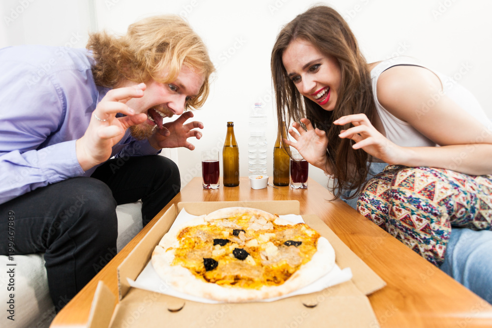 Couple eating pizza, having fun together. Couple eating pizza, having fun together.