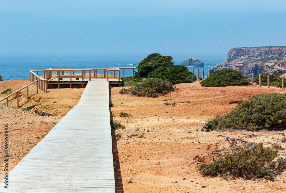 Wooden path and observation deck on summer Atlantic rocky coast
