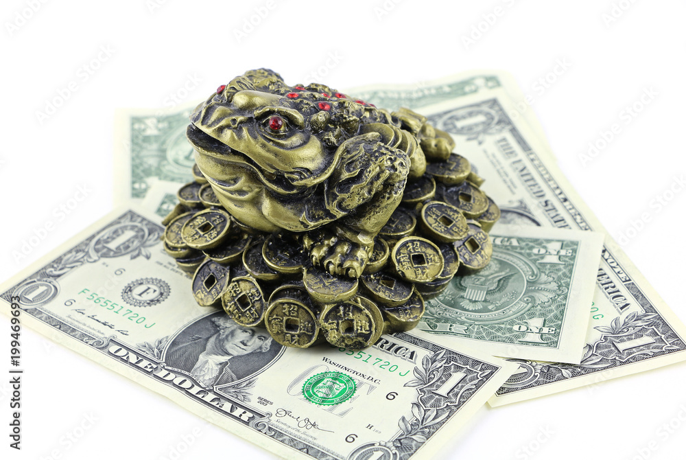Chinese Feng Shui lucky frog, toad with red eyes sits on coins and