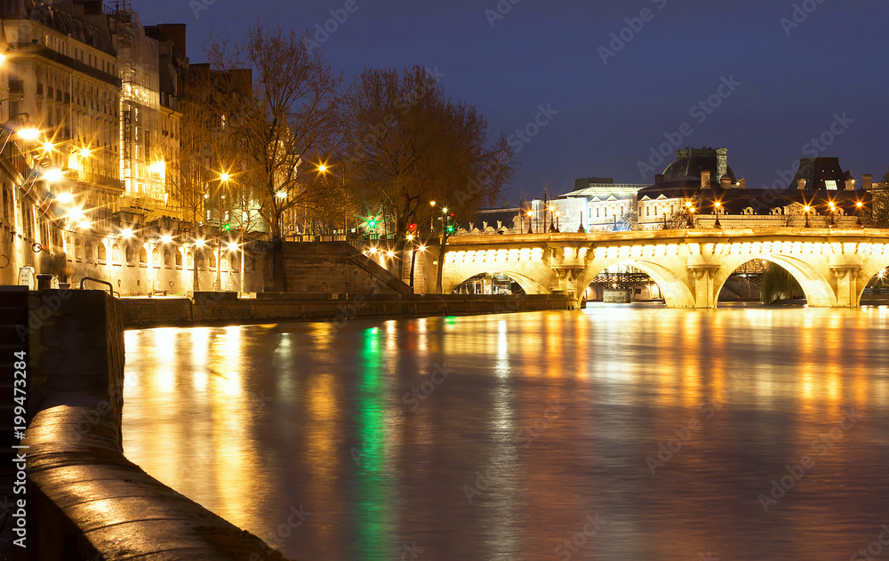 The Pont Neuf New Bridge and Seine river at night , Paris, France.