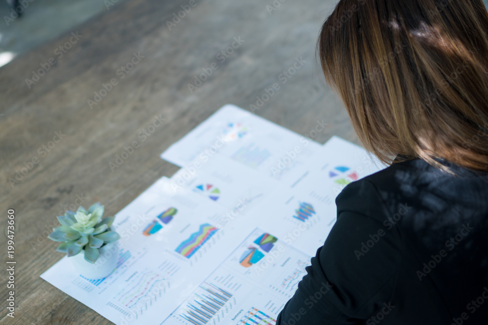 Businessmen are watching the summary report. And job evaluation graphs. selected focus, coffee break, relaxation. Businessmen are watching the summary report. And job evaluation graphs. selected focus, coffee break, relaxation.