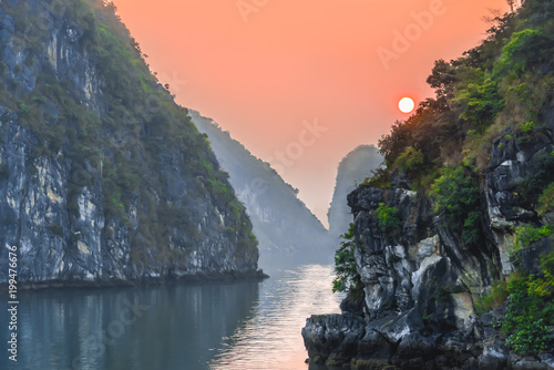 Sun rises over the Karst limestone islands of Halong Bay, Vietnam