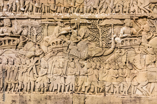 Picturial stories of the Khmer army marching to war carved into the wall at the Unesco World Heritage site of Ankor Thom, Siem Reap, Cambodia