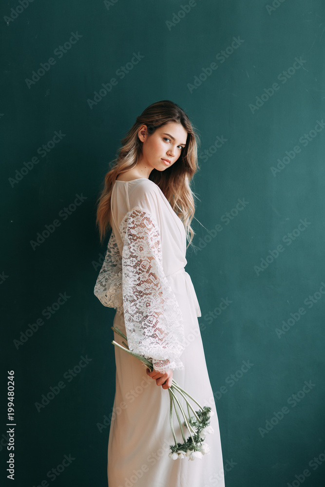 Young beautiful bride in boudoir and wedding dress, with a wreath and a bouquet in her hands. London wedding trends, stylish photoshoot Young beautiful bride in boudoir and wedding dress, with a wreath and a bouquet in her hands. London wedding trends, stylish photoshoot
