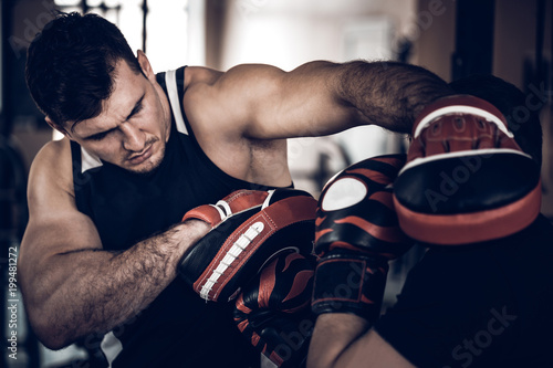 Boxing workout with trainer and punch mitts photo