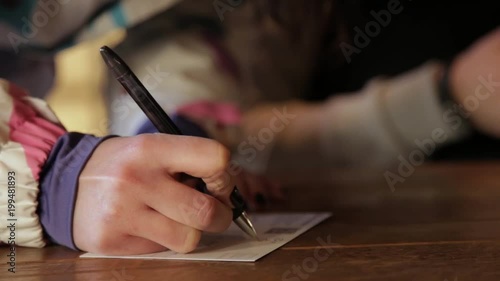Tourist woman writing postcard greeting card inside cafe