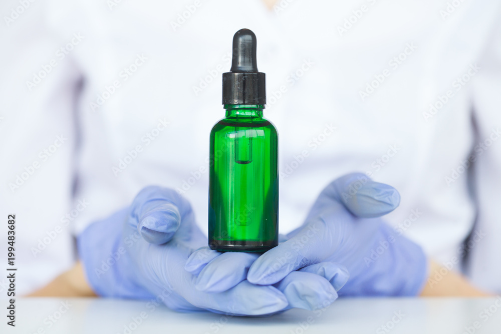 Scientist mixing natural organic extraction and green herbal leaves, Flower aroma essence solution in laboratory. Scientist mixing natural organic extraction and green herbal leaves, Flower aroma essence solution in laboratory.