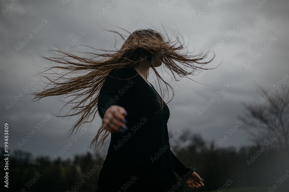 Woman With Long Hair Blowing in the Wind Stock Photo | Adobe Stock