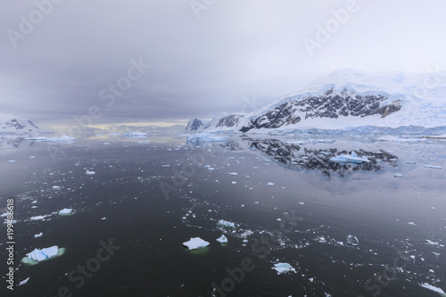 Atmospheric iceberg, mountain and glacier reflections, Neko Harbour, Andvord Bay, Graham Land, Antarctic Peninsula, Antarctica photo