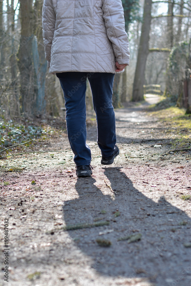 Lonely woman walking through the woods Lonely woman walking through the woods