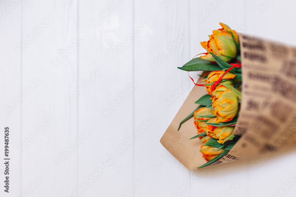 Bouquet of tulips in paper on white background
