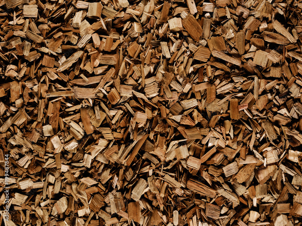 Dark brown wood chips create abstract rough-textured organic background surface Dark brown wood chips create abstract rough-textured organic background surface