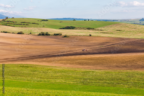 Summer hills landscape with tractor in Slovakia.