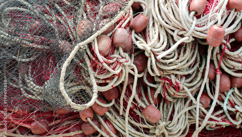 many nets and floats of the fishermen on the boat just moored many nets and floats of the fishermen on the boat just moored