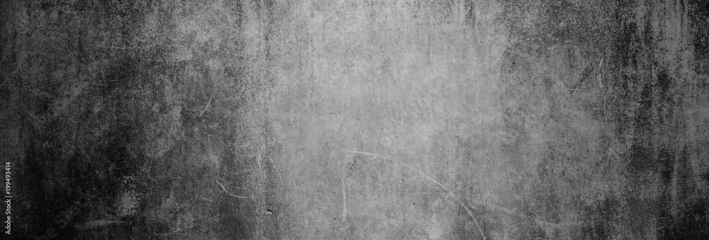 Textur einer dunklen, alten Betonwand als Hintergrund, auf die nur etwas Licht fällt